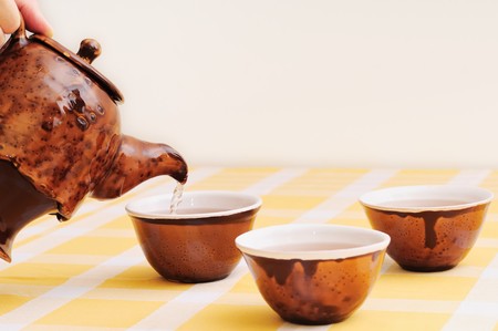 Pouring tea into cup (chinese style)の写真素材