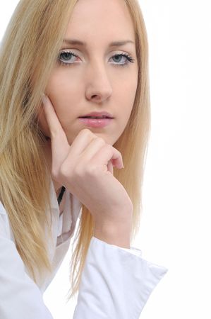 Portrait of young thoughtful business woman with hand under chin on whiteの写真素材