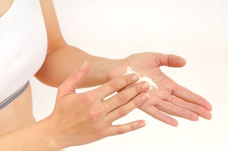 Woman in underwear applies cream on dry hands の写真素材