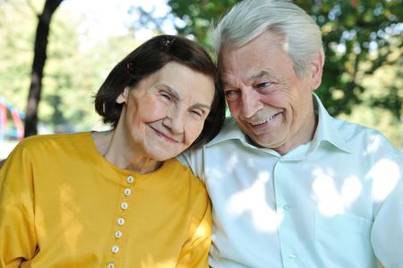 Portrait of happy senior man and woman outdoors in park     の写真素材