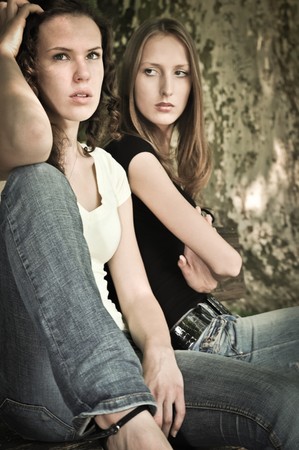 Friends outdoors series - two teenage girls are angry due to ther conflictの写真素材