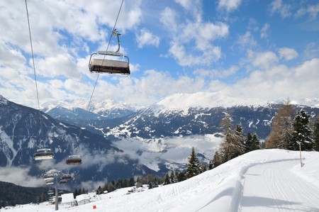 Empty ski lift in beautiful winter snowy mountain landscape (resort in Alps)の写真素材