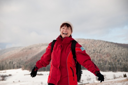 Winter portrait of senior mature in mountain snowy landの写真素材