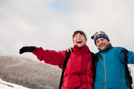 Winter fun - senior retired couple in snowの写真素材