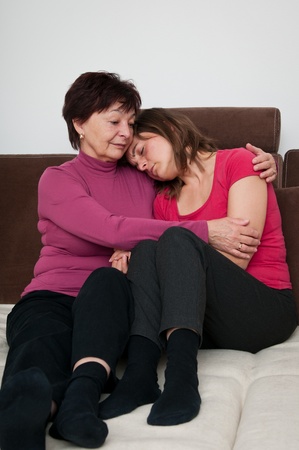 Big troubles - senior mother comforts daughterの写真素材
