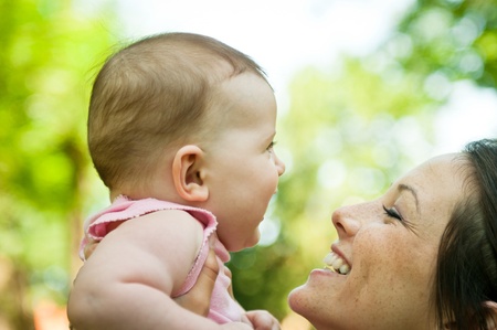 Happy mother holding her babyの写真素材