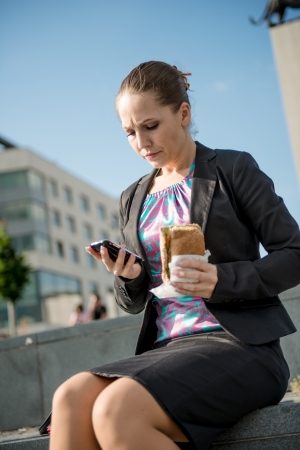 Business woman eating - problemsの写真素材