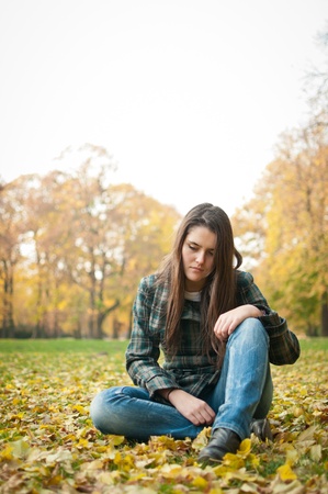 Young woman in depression outdoorの写真素材
