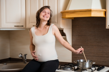 Pregnant woman cookingの写真素材