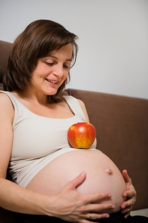 Pregnant woman and appleの写真素材