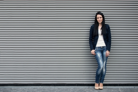 Woman portrait at striped wallの写真素材