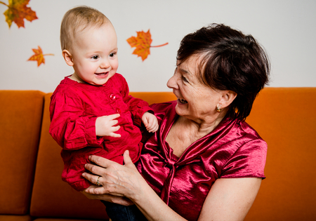 Indoor portrait of grandmother with her grandchildの写真素材