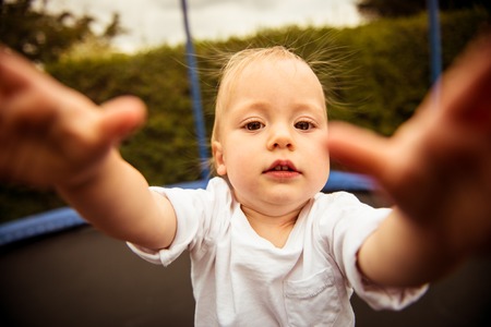 Baby trying to catch cameraの写真素材
