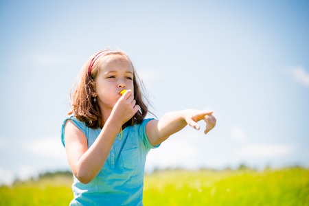 Child blowing whistleの写真素材