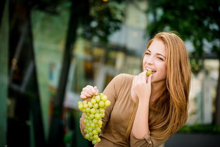 Teenager eating  grapesの写真素材