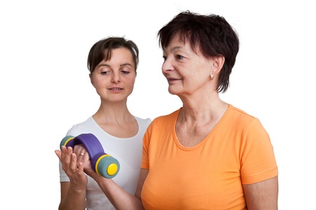 Coach assisting senior woman exercisingの写真素材