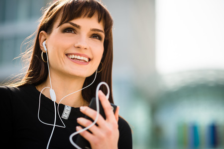 Woman calling phone in streetの写真素材