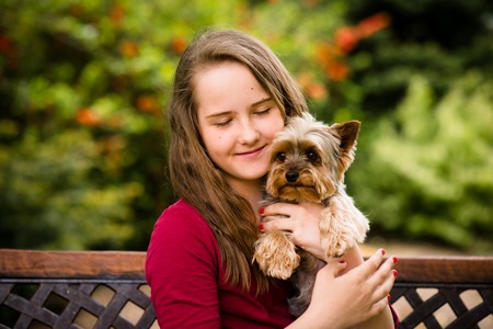 Girl hugging with her dogの写真素材