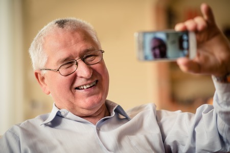 Senior man taking selfieの写真素材