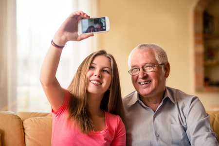 Grandfather with grandchild selfieの写真素材