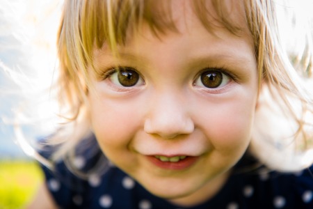 Detail of cute little girl looking to youの写真素材
