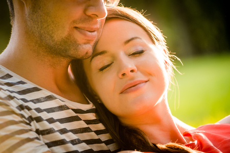 Intimate moments - young couple embracing and hugging in natureの写真素材