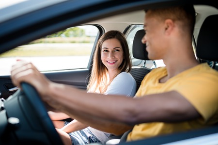 Young mixed ethnic couple together in car - man drivingの写真素材