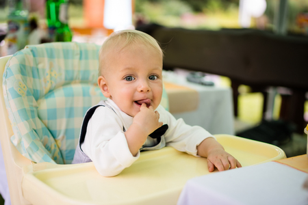 Baby boy sitting in a modern pramの写真素材