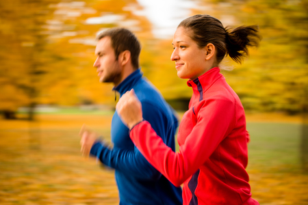 Couple jogging in nature - motion blurの写真素材