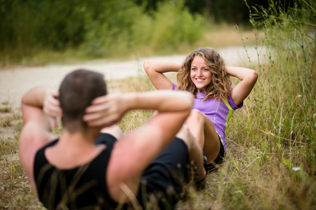 Healthy woman exercising with her boyfriend outdoorsの写真素材