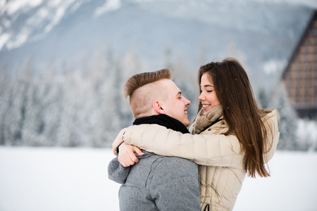 Couple embrace as they gaze at each otherの写真素材