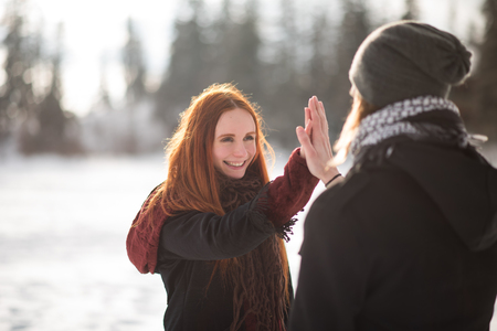 Cheerful couple giving each other high-fiveの写真素材