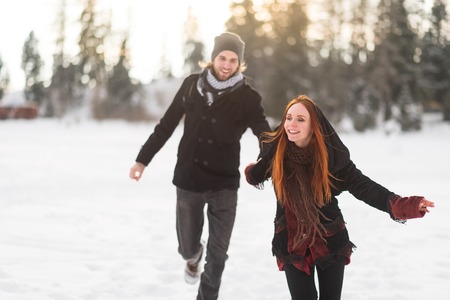Redhead woman leading her man to explore mountainsの写真素材