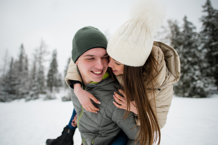 Young man giving his girlfriend piggyback rideの写真素材