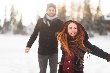 Cheerful girlfriend holding her mans hand while runningの写真素材