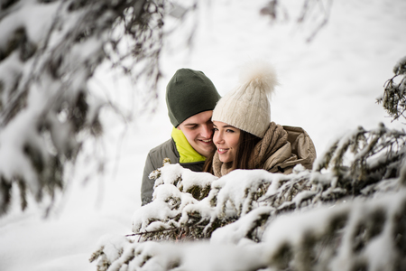 Young couple in love - snowy background.の写真素材