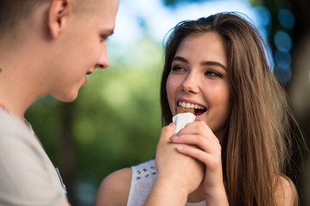 Young enamoured couple enjoying chocolate barの写真素材