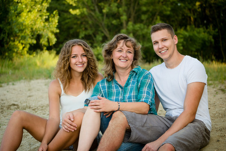 Happy mother, son and daughter outdoors. Affectionate family.の写真素材