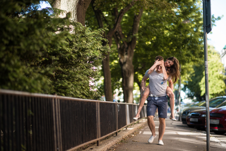 Playful woman enjoying the piggy rideの写真素材