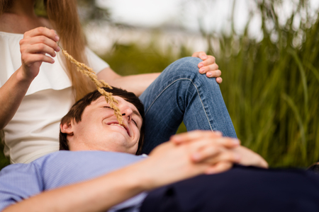 Smiling man lying over his womans lapの写真素材
