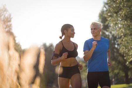 Slim healthy couple training for cardio outdoorsの写真素材