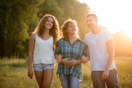 Outdoor portrait of smiling happy senior mother with her childrenの写真素材