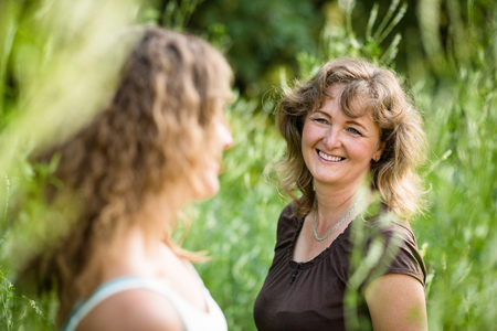 Smiling mother and daughter, outdoor shot.の写真素材