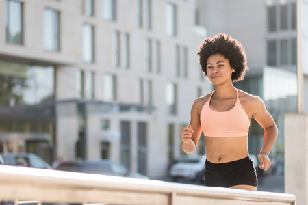Fitness athlete running outdoors. Cardio workout.の写真素材