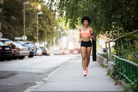 Healthy woman runner listening to music.の写真素材