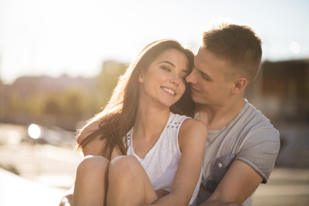 Happy young couple embracing outdoorsの写真素材