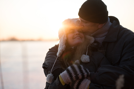 Man kissing his partner on foreheadの写真素材