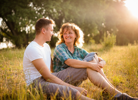 Happy mother and son smiling together as they face each otherの写真素材