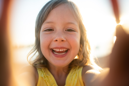 Smiling girl child staring at cameraの写真素材