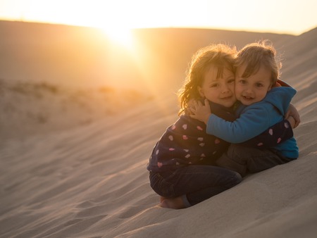 Little boy and girl hugging each otherの写真素材
